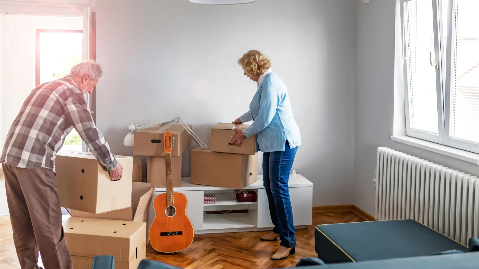 An elderly couple getting house clearance items together