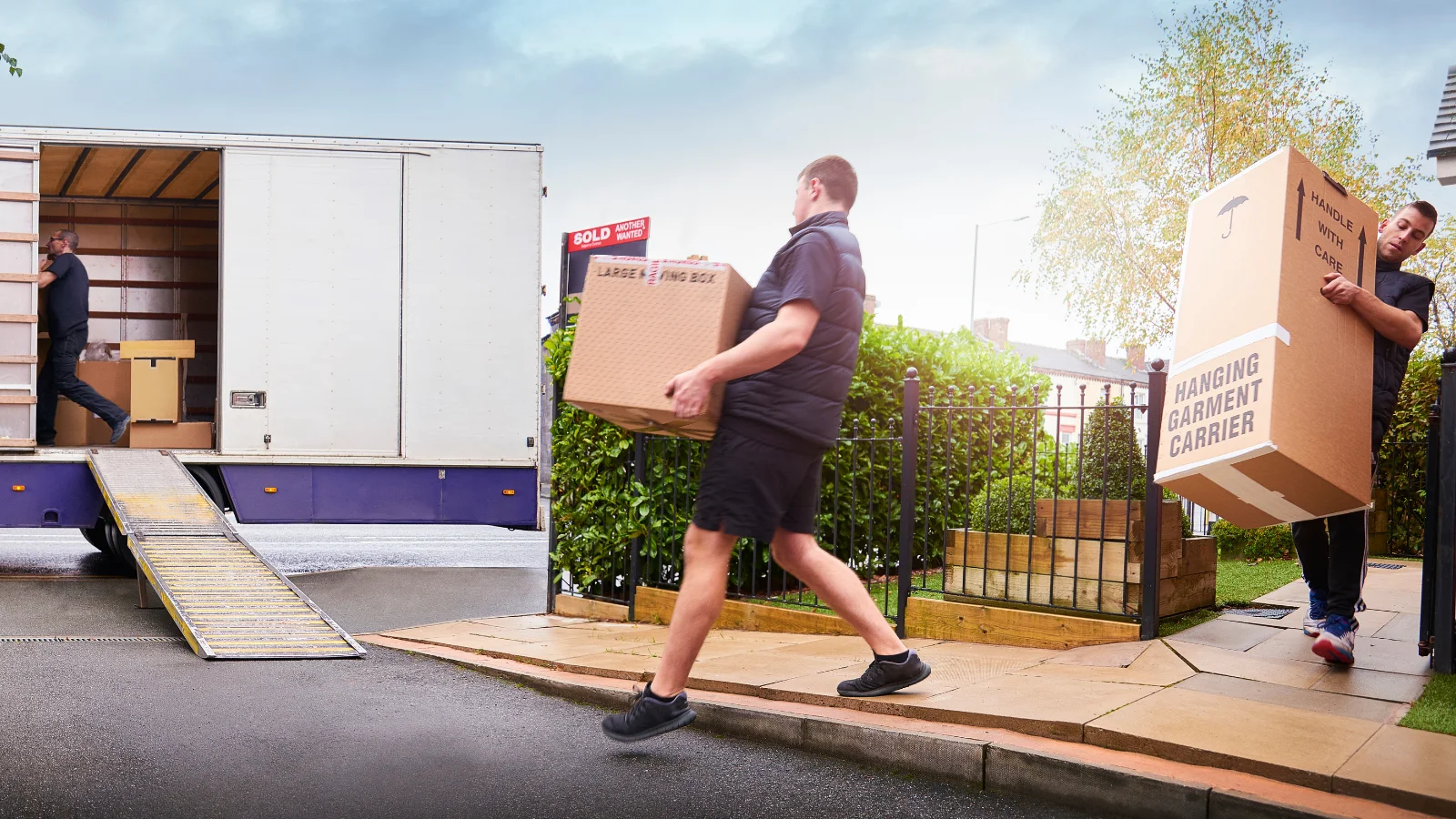 Men moving boxes to a truck